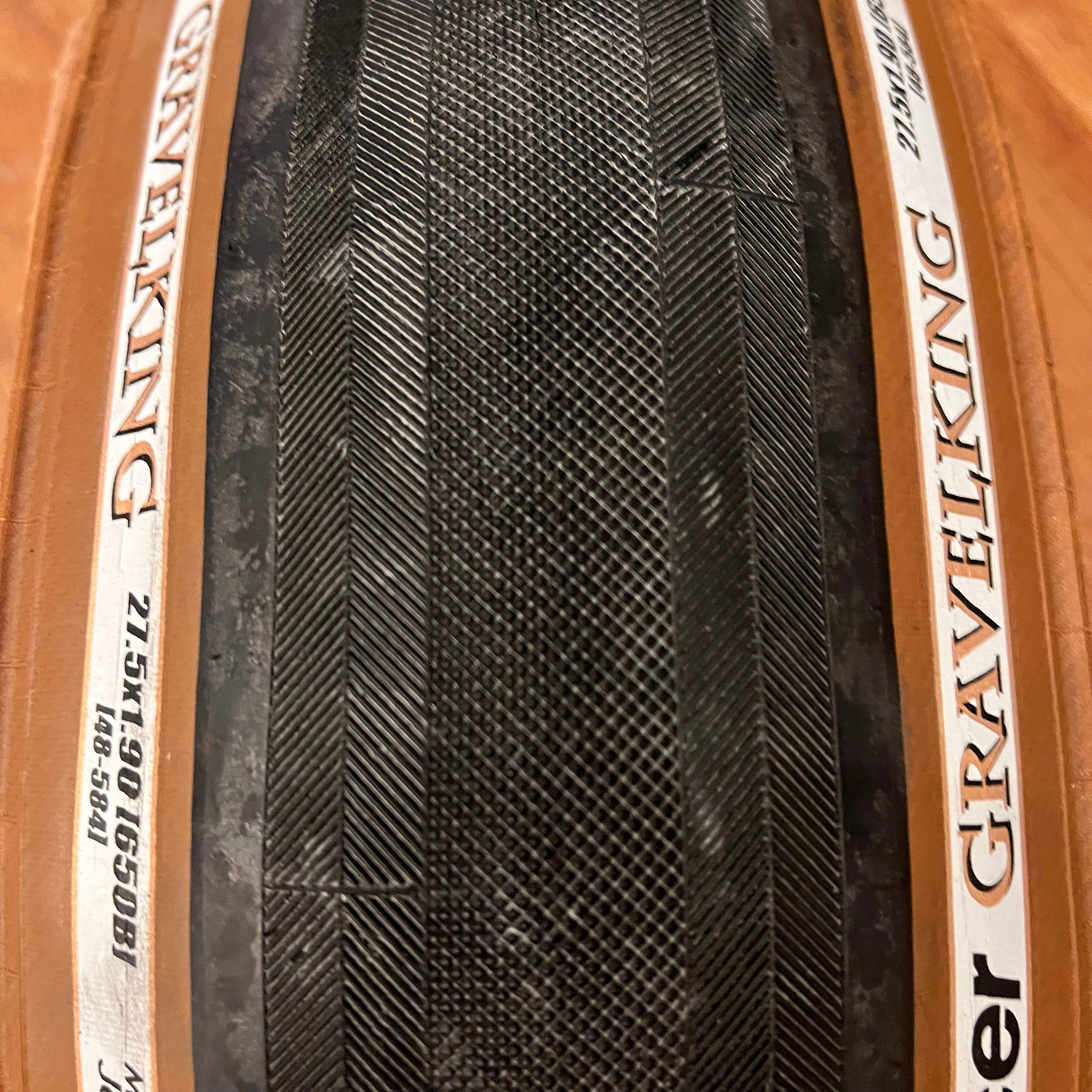 A photo of the tread of the Panaracer GravelKing Brown Wall SLICK 27.5x1.90" Tubeless Tire.