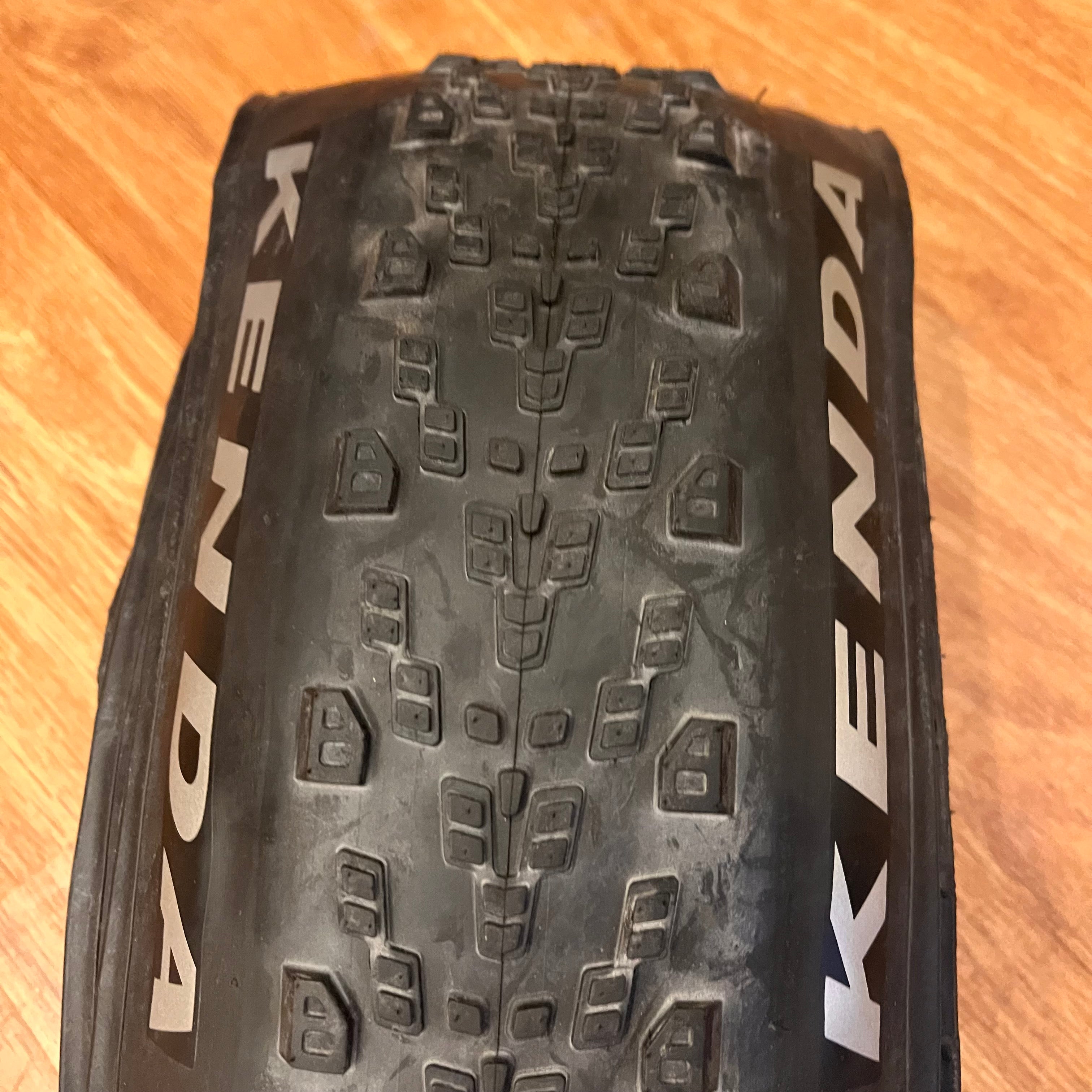 Photo showing a tread closeup of the Kenda Saber Pro 27.5x2.20 folding tire.