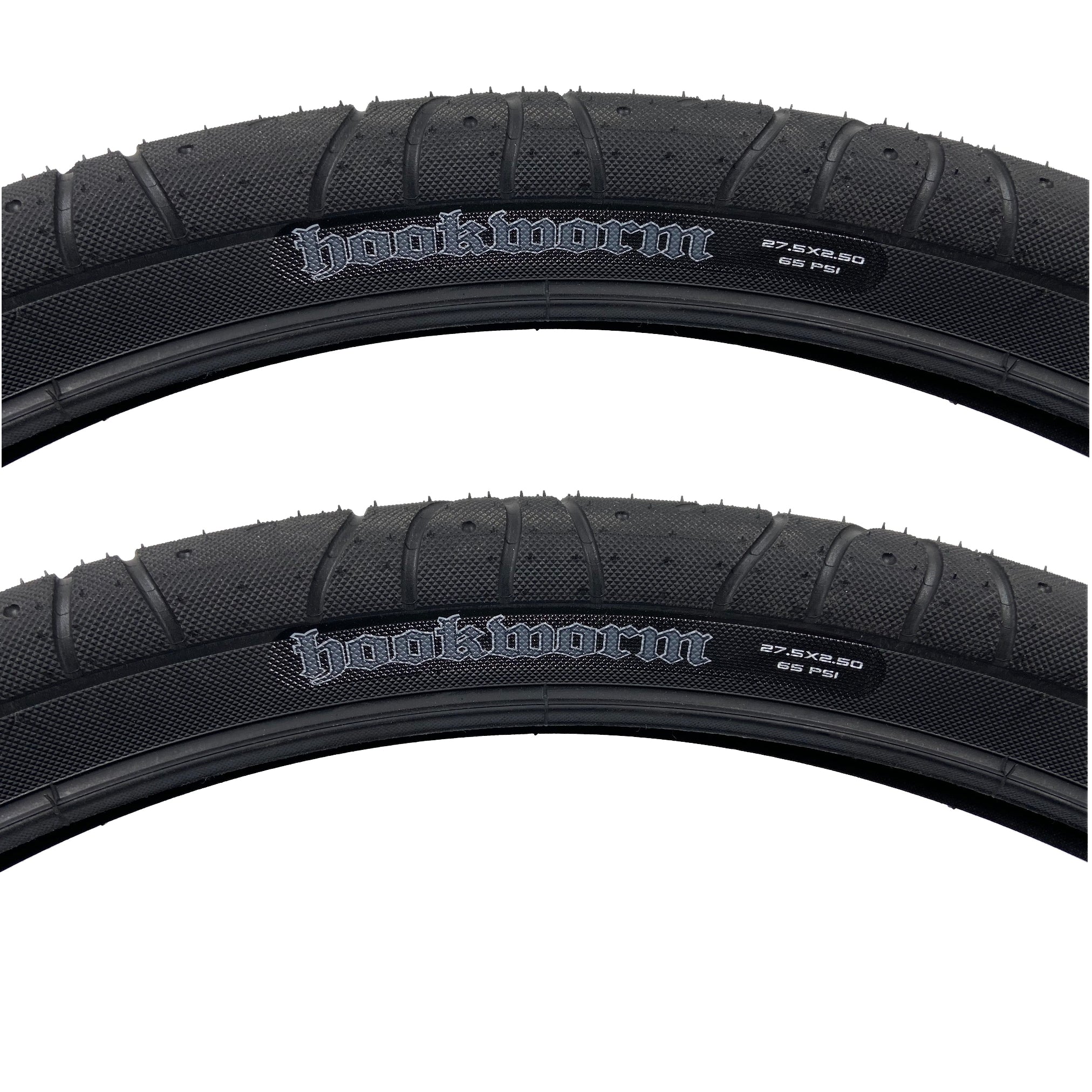 Photo showing a close up of two of the Maxxis Hookworm 27.5"x2.5 tires. The Hookworm logo can be seen on the sidewall as well as the size and the max PSI rating of 65