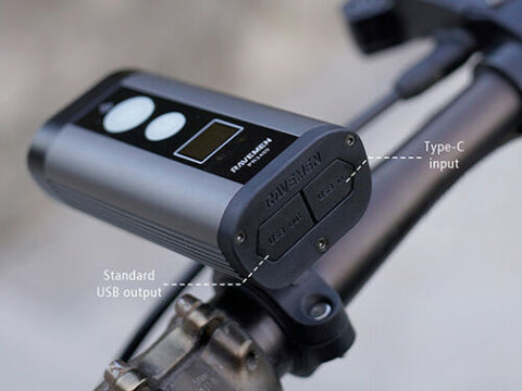 Image of Ravemen Wireless 900/2400 LUMEN USB RECHARGEABLE HEADLIGHT on a handlebar.  You have the option to use the USB-C input or the standard USB output.
